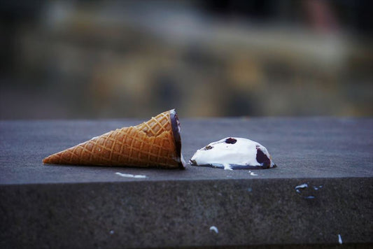 Ice cream cone on ground. Image by Sarah Kilian on Unsplash.
