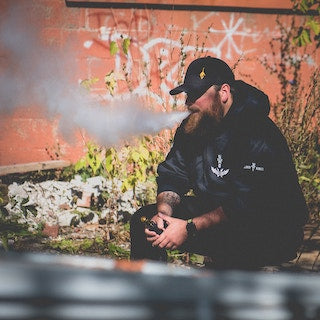 Man Sitting Down Vaping, Photo by Troy T on Unsplash