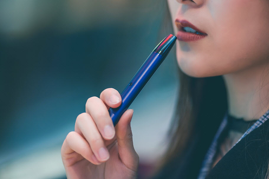 Woman using e-cig. Photo by Thorn Yang from Pexels
