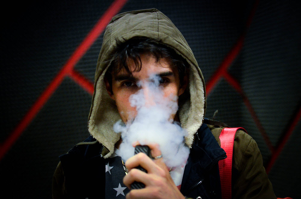 Hooded man vaping. Photo by Nery Zarate on Unsplash