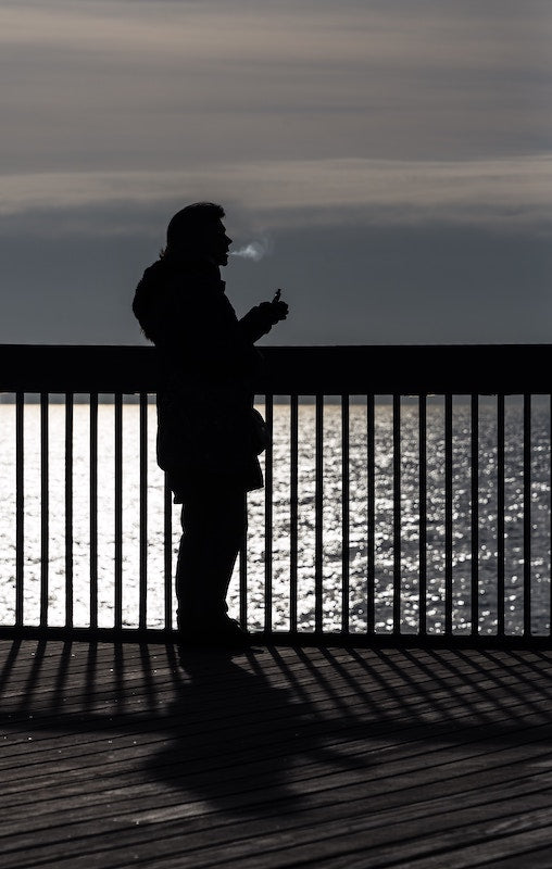 Man Vaping By Water, Photo by Richard R Schünemann on Unsplash