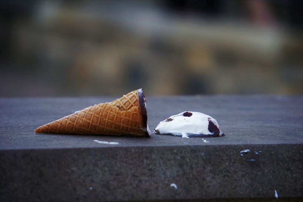 Ice cream cone on ground. Image by Sarah Kilian on Unsplash. 